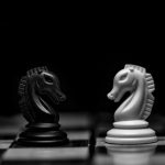 Chess Pieces - white ceramic figurine on black table