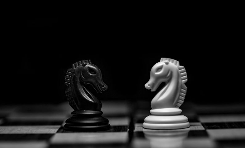 Chess Pieces - white ceramic figurine on black table