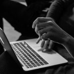 Accessibility Online - grayscale photo of person using MacBook