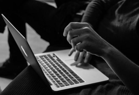 Accessibility Online - grayscale photo of person using MacBook