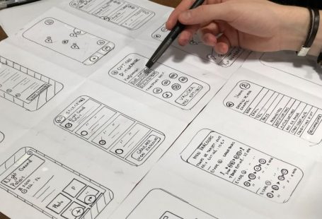 UX Design - person holding pen near paper