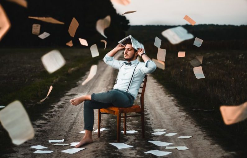 Storytelling Book - man sitting on chair with book