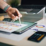 Impact Analytics - a person is writing on a piece of paper