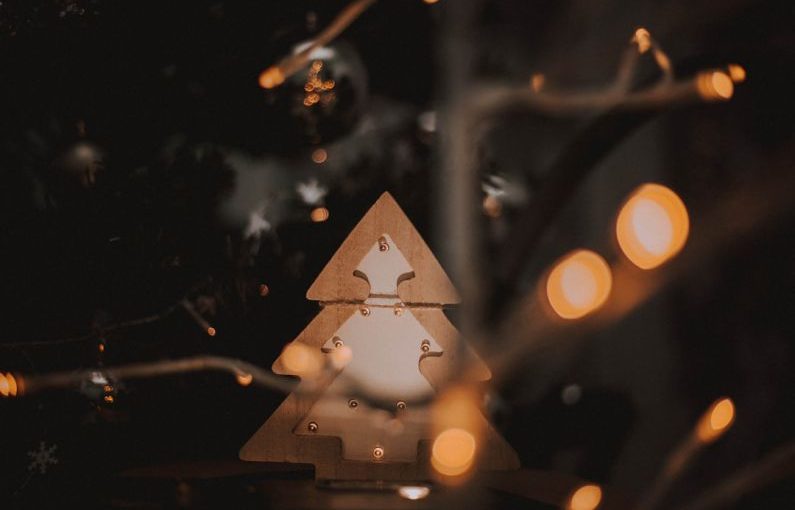 Trends Forecast - a wooden christmas tree with lights around it