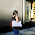 Shopping Behavior - woman in white shirt and blue denim jeans standing in front of mirror