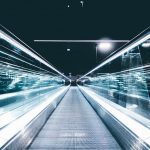 SEO Future Trends - gray conveyor between glass frames at nighttime