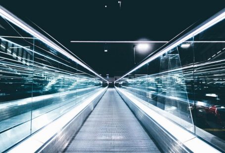 SEO Future Trends - gray conveyor between glass frames at nighttime