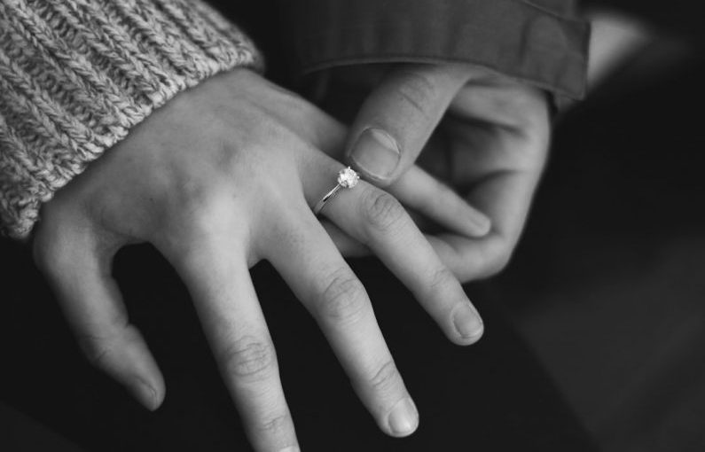 Visual Engagement - woman wearing wedding ring with man holding hand