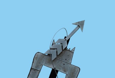 Trend Arrows - a metal sculpture of a person riding a horse