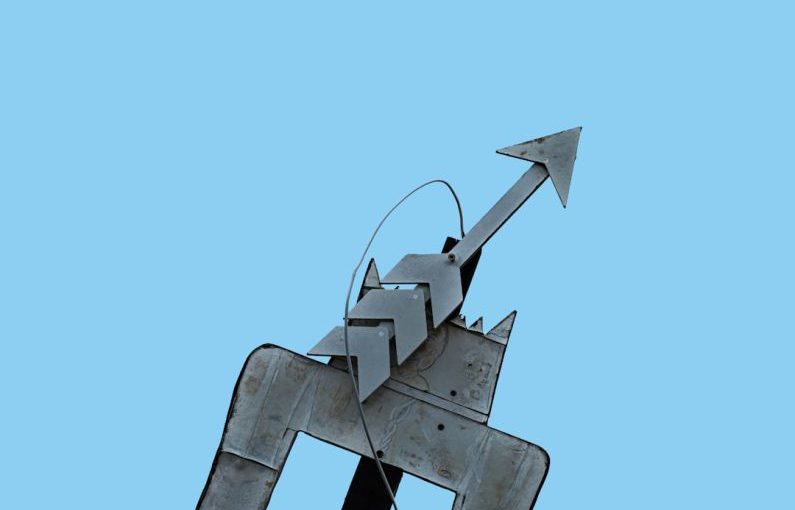 Trend Arrows - a metal sculpture of a person riding a horse