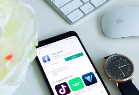 TikTok Marketing - black android smartphone beside silver and gold round analog watch