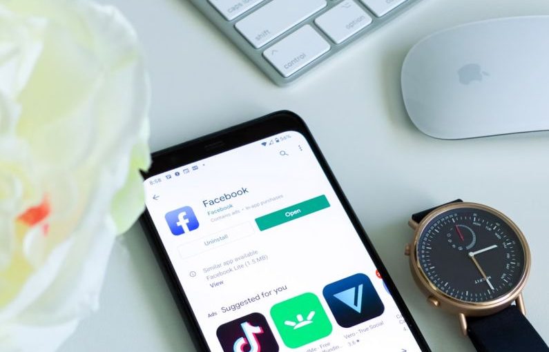 TikTok Marketing - black android smartphone beside silver and gold round analog watch