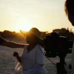 Ad Visuals - person taking photo of man and woman during golden hour
