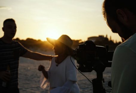 Ad Visuals - person taking photo of man and woman during golden hour
