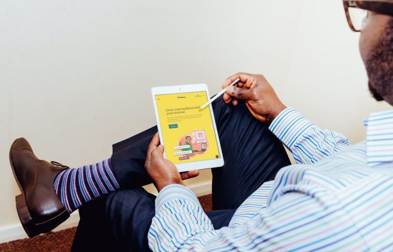 Cross-platform Branding - a man holding a tablet