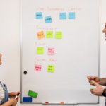 UGC Marketing - a man and a woman standing in front of a white board