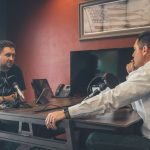 Podcast Marketing - man sitting in front of another man also sitting inside room