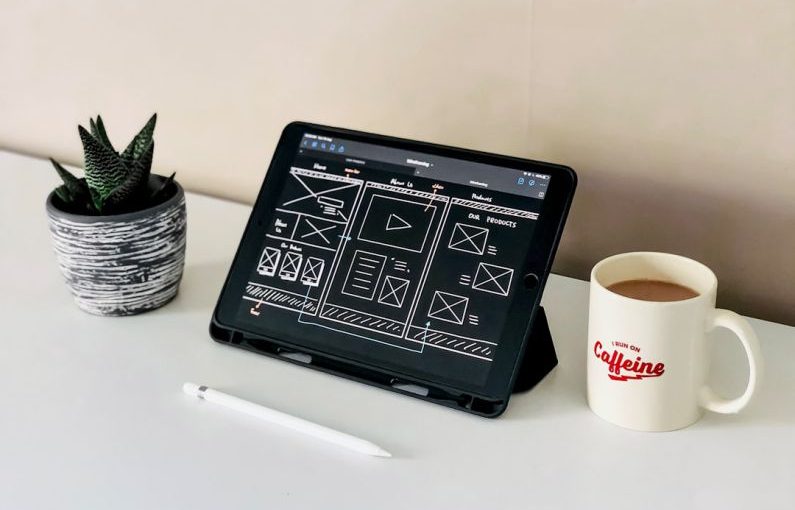 Website Design - black ipad beside white ceramic mug on white table